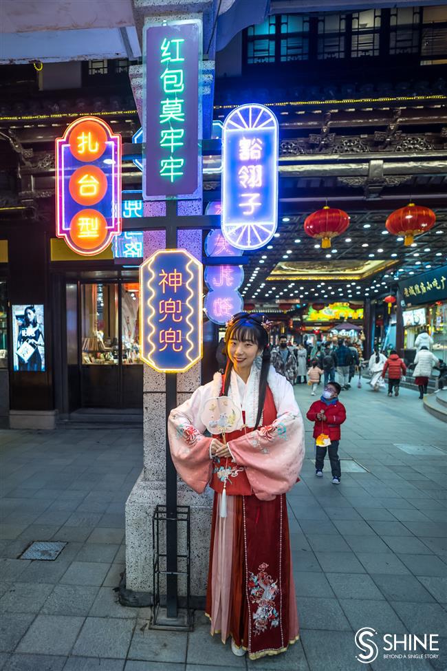 in <i>hanfu</i> costume, soaking up culture in the city's traditional lantern fair