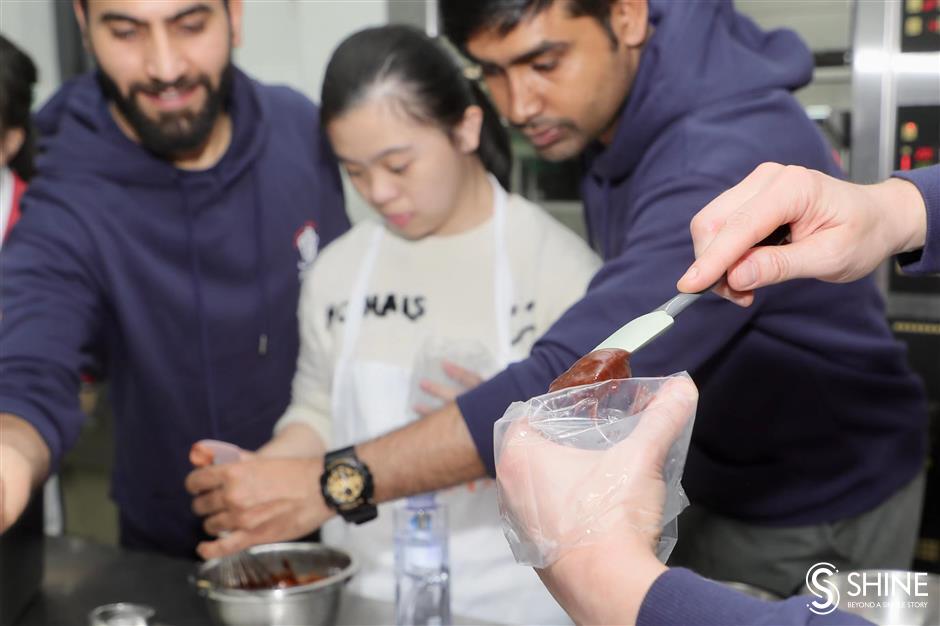 global volunteers come together to bake and learn with special needs students in shanghai