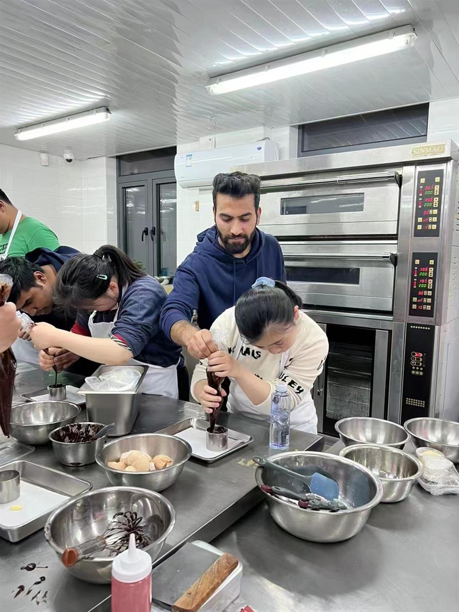 global volunteers come together to bake and learn with special needs students in shanghai