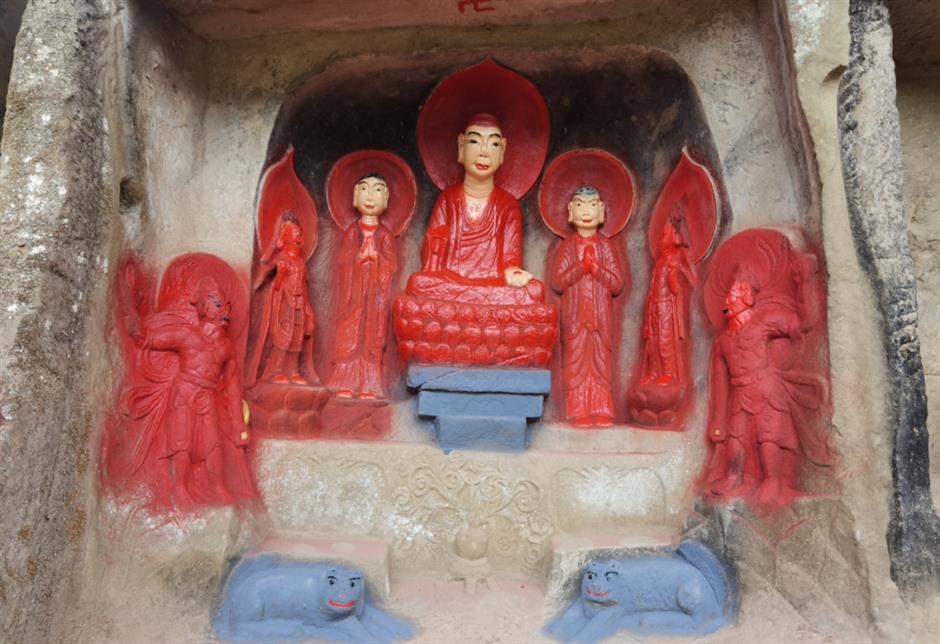 public sees red as buddhist cliff carvings painted in bright colors